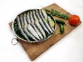 Closeup view of Fresh Indian oil Sardine decorated with herbs and vegetables Selective focus.White Background