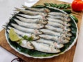 Closeup view of Fresh Indian oil Sardine decorated with herbs and vegetables Selective focus.White Background