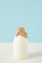 closeup view of fresh milk in bottle wrapped by paper on blue background Royalty Free Stock Photo