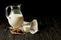 closeup view of fresh milk in jug and glass, chocolate cookies and sackcloth on black background Royalty Free Stock Photo