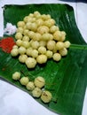 Closeup view of fresh star gooseberry with salt and red chilli powder on green banana leaf.
