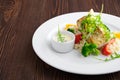 Closeup view of fried zander with rice, bell pepper and arugula served with mayonnaise sauce