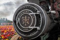 Up close view of a front part of a steam engine with engraving on it Royalty Free Stock Photo