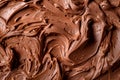 A closeup view of a generous swirl of chocolate whipped cream or smooth chocolate cream as background Royalty Free Stock Photo