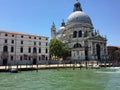 A closeup view from the Grand Canal of Santa Maria della Salute with two gondolas in front. Royalty Free Stock Photo