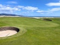 A closeup view of a green and pot bunker on a classic links style course in Brora