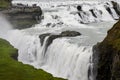Closeup view of Gullfoss waterfall with group of tourists