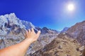 Closeup view of hand on beautiful panoramic mountain view of Everest Region