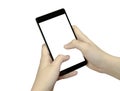 Closeup view of a hand with fingers holding a black cell phone with white screen on wooden mat blur