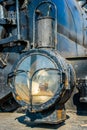Closeup view of a headlight of the ancient steam locomotive. Pet