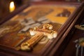 Closeup view of a holy wooden Christian cross on a blurred icon