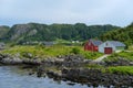 Closeup view of houses at the rocky coastlne in Refviksanden Beach