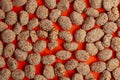 Indian sweet item called Rewri or Revdi isolated on orange background. Top view. Royalty Free Stock Photo