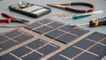 A closeup view of the individual components used in a homemade solar panel project. There are solar cells arranged in a Royalty Free Stock Photo