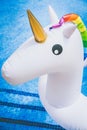 Closeup view of Inflatable colorful white unicorn at the swimming pool. Fun time in the Summer at swimming pool. concept