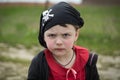 Closeup view of little serious pirate girl portrait wearing black banadana
