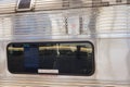 Closeup view of a long window of a silver subway train