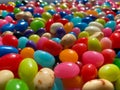 Closeup view looking at gourmet flavored jelly beans in various colors with shining light above Royalty Free Stock Photo