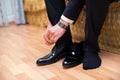 Closeup view of male hands lacing beautiful elegant shoes. wedding day. groom tie his shoe . Man wearing a suit putting his brown Royalty Free Stock Photo