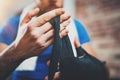 Closeup view on male hands of young athlete tying black boxing bandages.Boxer man relaxing after hard kickboxing Royalty Free Stock Photo