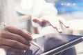 Closeup view of man holding digital tablet on hand and using electronic pen while working at sunny office.Pointing Royalty Free Stock Photo