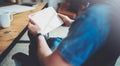 Closeup view of man holding digital tablet on hand and using while sitting in armchair at coworking place. Pointing hand Royalty Free Stock Photo