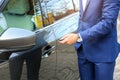 Closeup view of man opening car door with key Royalty Free Stock Photo