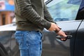 Closeup view of man opening car door with key Royalty Free Stock Photo