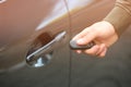 Closeup view of man opening car door with key Royalty Free Stock Photo