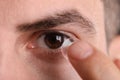 Closeup view of man putting contact lens in his eye Royalty Free Stock Photo