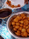 Closeup view of man serving Indian desert stuffed kachori to people