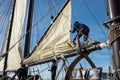 Closeup view of a man setting a sails at a Spanish tall ship Pascual Flores company