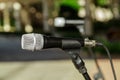 Closeup view of microphone detailed head against blurred outdoor background