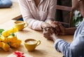 Close up view of millennial black couple holding hands at coffee shop