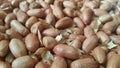 Closeup view of mixed, dried, roasted peeled and unpeeled peanuts