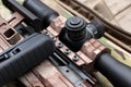 Closeup view of modern powerful sniper rifle with telescopic sight on blurred background Royalty Free Stock Photo