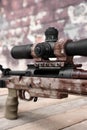 Closeup view of modern powerful sniper rifle with telescopic sight Royalty Free Stock Photo