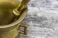 Closeup view of the mortar brass standing on the old wooden desk