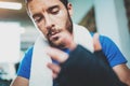 Closeup view of Muscular Boxer man prepairing hands for hard kickboxing training session in gym. Young athlete tying Royalty Free Stock Photo