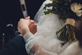 Closeup view of newlyweds hands holding colorful wedding bouquet. Bride and groom wearing wedding rings. Outdoor Royalty Free Stock Photo