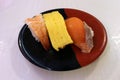 Closeup of nigiri sushi of ebi (shrimp or prawn), fish, and egg