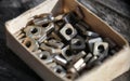 Closeup view nuts and screws in Matchbox Various metal details in cardboard box Royalty Free Stock Photo