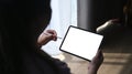 Closeup view of obese woman holding stylus pen and using digital tablet.