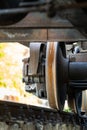 Closeup view of old rusty wheels of train. Railroad car chassis on rail.