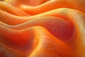 Closeup view of orange fabric with intricate pattern. Soft textured fabric curves smoothly. Design features dotted pattern with Royalty Free Stock Photo