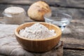 Closeup view of organic whole spelt flour in wooden cup