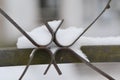 Closeup view of part iron fence with snow cover. Winter snow texture