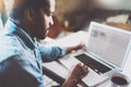 Closeup view of pensive African man working on laptop while spending time at home.Concept young business people using Royalty Free Stock Photo