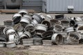 Old Car Rims Pile at Scrapheap Junkyard. Stack of old discarded wheels, metal recycling industry