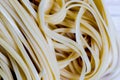 Closeup view of a Pile Of Uncooked Rolled Traditional Italian Pasta